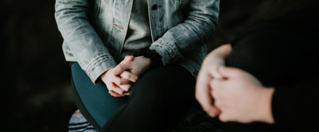 Girl in blue sitting on a sofa in therapy | Individual Therapy